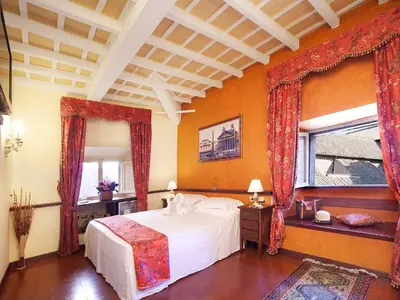a bedroom with a white bed and two windows at Pantheon Inn in Rome