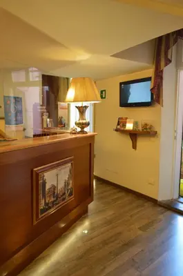 a living room with a lamp and a flat screen tv at Pantheon Inn in Rome