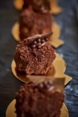 a group of chocolate cakes on plates on a table at Rome Cavalieri, A Waldorf Astoria Hotel in Rome