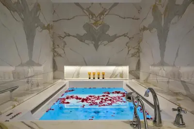 a tub filled with red confetti in a bathroom at Hotel Splendide Royal - The Leading Hotels of the World in Rome