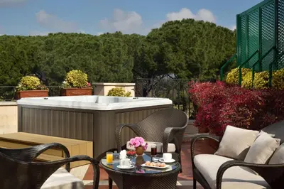 a hot tub on a patio with chairs and a table at Hotel Splendide Royal - The Leading Hotels of the World in Rome