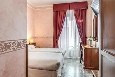 a hotel room with a bed and a window at Hotel Orazia in Rome