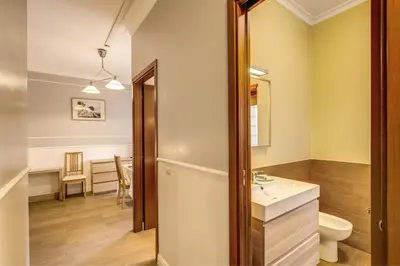 a bathroom with a sink and a toilet in a room at Hotel Residence Magnolia in Rome