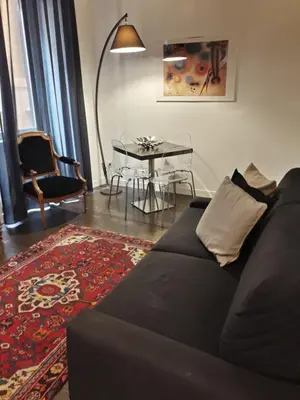 a living room with a black couch and a table at EasyInRome Navona in Rome
