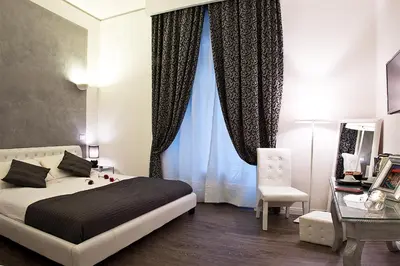 a bedroom with a bed and a chair and a window at Rome Key Home in Rome