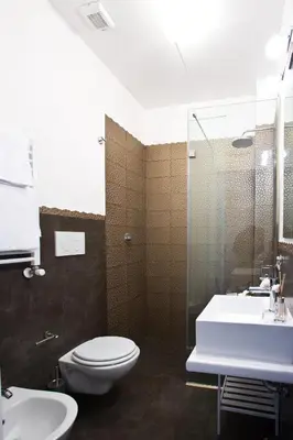 a bathroom with a toilet and a sink and a shower at Rome Key Home in Rome