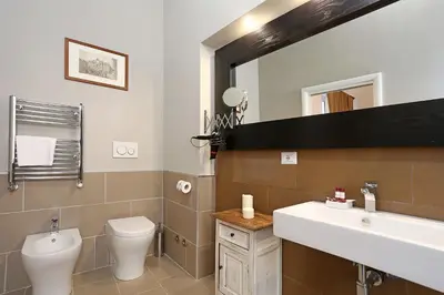 a bathroom with a sink and a toilet and a mirror at Juno Pantheon in Rome