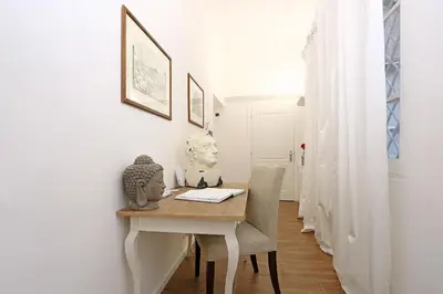 a dining room with a table with a bust on it at Juno Pantheon in Rome
