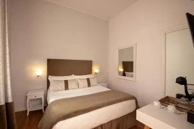 a hotel room with a large bed and a window at Juno Pantheon in Rome