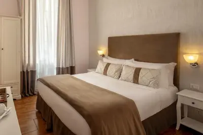 a bedroom with a large bed in a hotel room at Juno Pantheon in Rome
