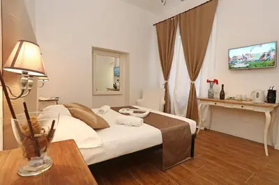 a bedroom with a bed and a table with a lamp at Juno Pantheon in Rome