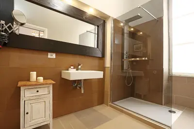 a bathroom with a sink and a shower with a mirror at Juno Pantheon in Rome
