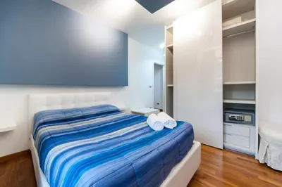 a bedroom with a large bed with towels on it at Il Rosso e il Blu in Rome