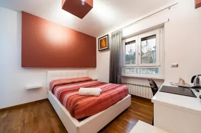 a small bedroom with a bed and a sink at Il Rosso e il Blu in Rome