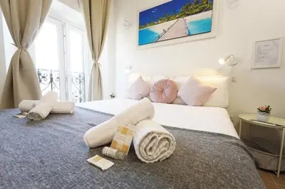 a hotel room with a bed with towels on it at Cicero Rome Center in Rome