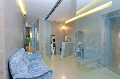 a living room with a couch and a glass wall at Mama's Home Rome in Rome
