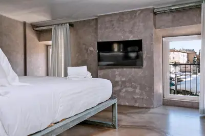 a bedroom with a large bed and a window at Mama's Home Rome in Rome