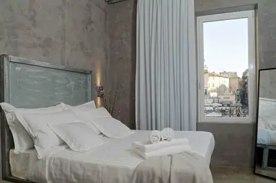 a bedroom with a white bed with towels on it at Mama's Home Rome in Rome