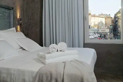 a hotel room with a bed with towels on it at Mama's Home Rome in Rome