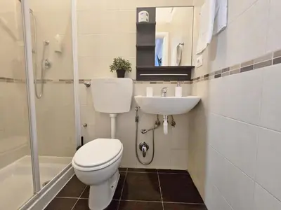 a bathroom with a toilet and a sink at Hosting Flats Hospety Group in Rome