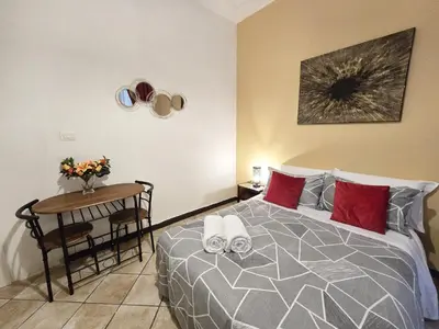 a bedroom with a bed and a table with a table at Hosting Flats Hospety Group in Rome