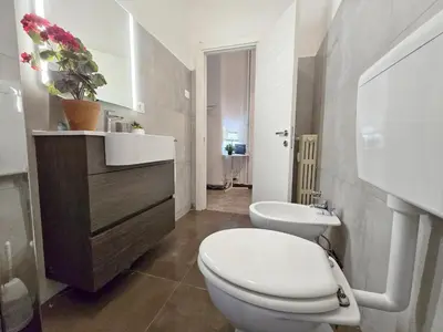 a bathroom with a white toilet and a sink at Hosting Flats Hospety Group in Rome