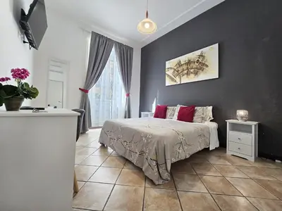 a bedroom with a bed and a wall at Hosting Flats Hospety Group in Rome