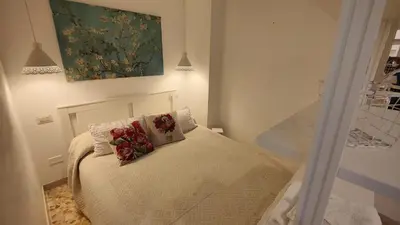 a small bedroom with a bed with flowers on it at Sergio Tourist Rental close Tiburtina Station in Rome