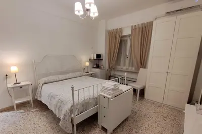a white bedroom with a bed and a window at Sergio Tourist Rental close Tiburtina Station in Rome