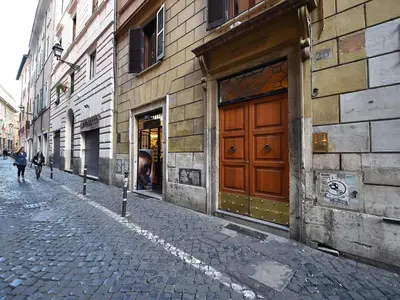 a cobblestone street with a brown door on a building at Ascanio Twenty Six in Rome