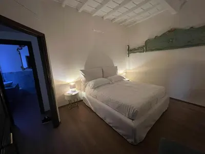 a bedroom with a white bed and a side table at Ascanio Twenty Six in Rome