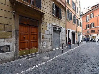 a person walking down a street next to a building at Ascanio Twenty Six in Rome