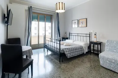 a bedroom with a bed and a couch and a chair at La Casa In Prati in Rome