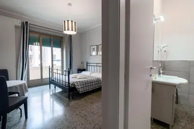a bedroom with a bed and a sink in a room at La Casa In Prati in Rome