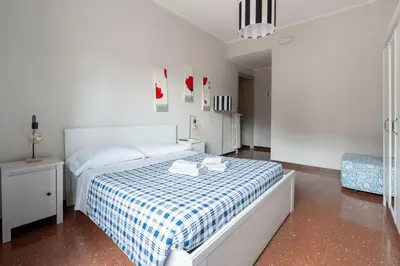 a bedroom with a bed with a blue and white checked blanket at La Casa In Prati in Rome