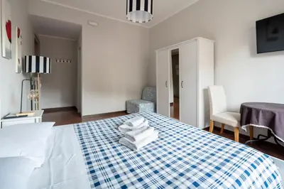 a bedroom with a blue and white bed with towels on it at La Casa In Prati in Rome