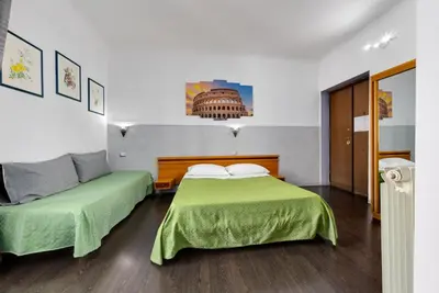 a bedroom with two beds with green sheets at Penelope Holiday in Rome