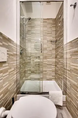 a bathroom with a shower with a toilet and a tub at Penelope Holiday in Rome
