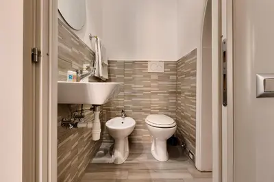 a bathroom with a sink and a toilet at Penelope Holiday in Rome