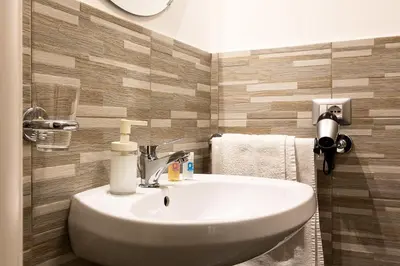 a bathroom with a white sink in a room at Penelope Holiday in Rome