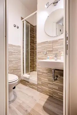 a bathroom with a sink and a toilet and a mirror at Penelope Holiday in Rome