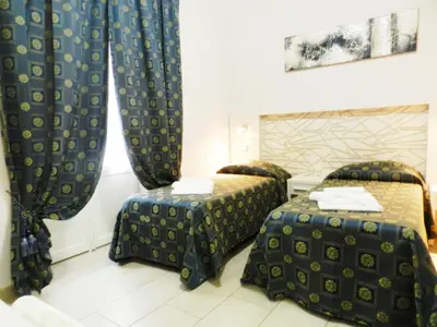 a hotel room with two beds and curtains at Vatican Rome in Rome