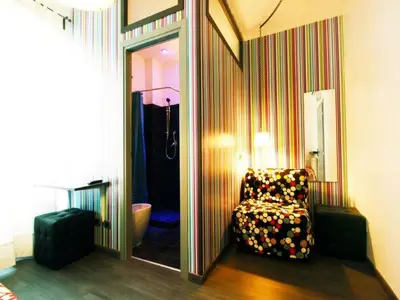 a room with a chair in front of a mirror at Affittacamere Tiburstation in Rome