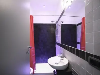 a bathroom with a sink and a shower with a mirror at Affittacamere Tiburstation in Rome