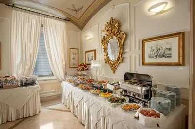 a buffet table with food on it in a room at Hotel Canada, BW Premier Collection in Rome