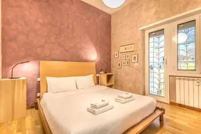 a bedroom with a large bed with towels on it at Il gazebo a Monteverde in Rome