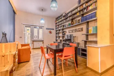 a dining room with a table and orange chairs at Il gazebo a Monteverde in Rome