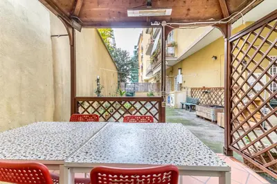 a table and chairs on a balcony with a table at Il gazebo a Monteverde in Rome