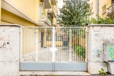 a white gate in front of a building at Il gazebo a Monteverde in Rome