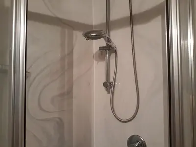 a shower with a shower head in a bathroom at 2 Be Home Colosseo in Rome